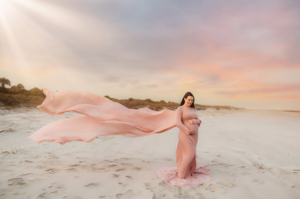 Pregnant woman poses for Maternity Photoshoot on Folly Beach in Charleston, South Carolina after researching Top Ten Ideas for Planning your Babymoon in Charleston.