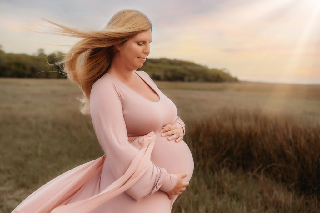 Pregnant woman poses for Maternity Photos in Charleston, South Carolina after working with the Best Fertility Specialists in Charleston. 