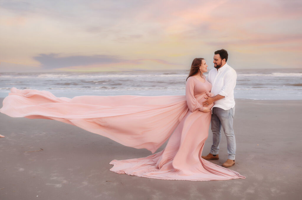 Expectant parents pose for Maternity Photoshoot on Folly Beach in Charleston, South Carolina after researching Top Ten Ideas for Planning your Babymoon in Charleston.