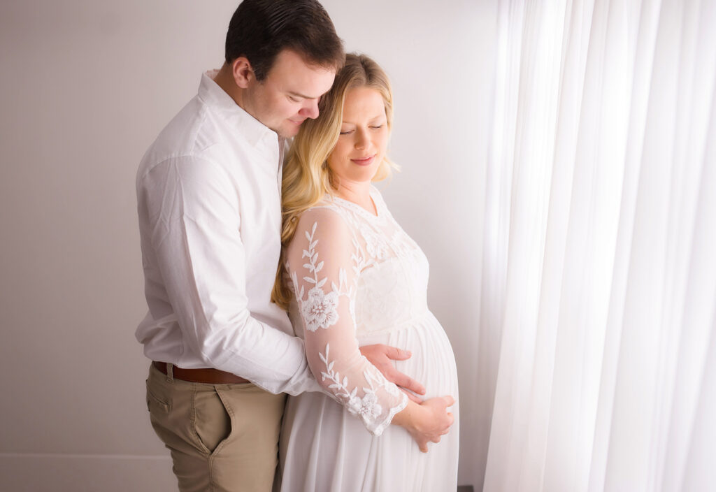 Expectant parents embrace during Maternity Photoshoot in Charleston. 
