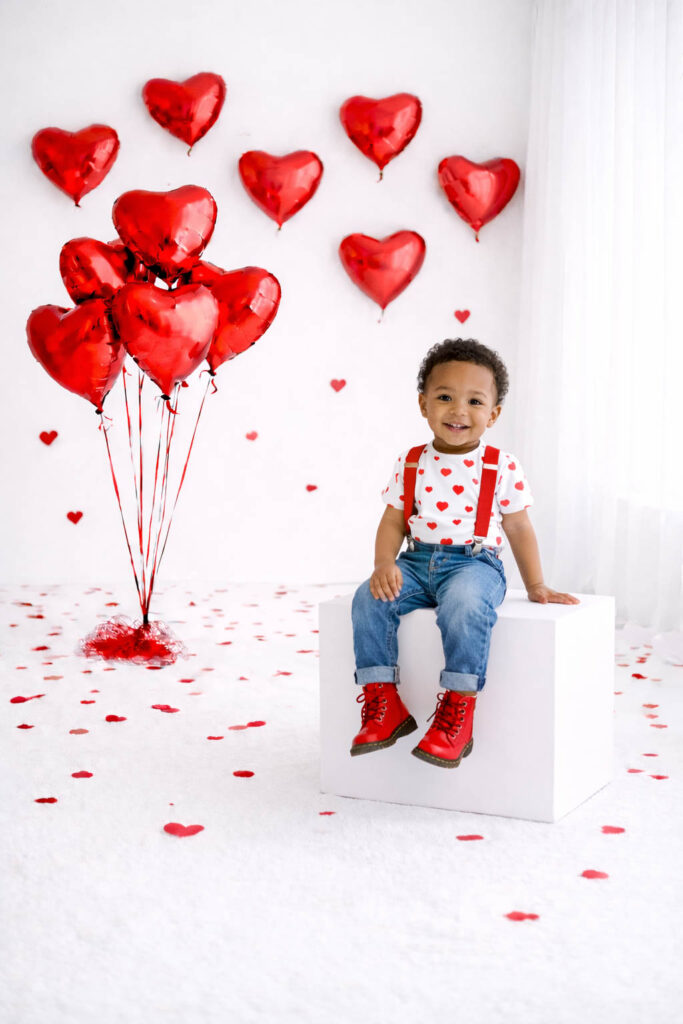 Toddler smiles at the camera during Valentine's Mini Session in Charleston.