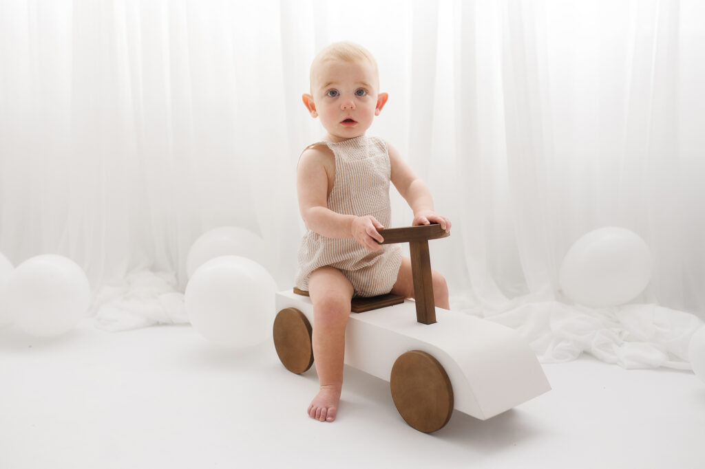 Baby sits for Birthday Cake Smash Photography in Charleston, SC Portrait Studio - Holy City Babies. 