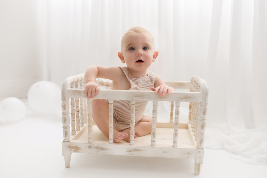 Baby sits for Birthday Cake Smash Photography in Charleston, SC Portrait Studio - Holy City Babies. 