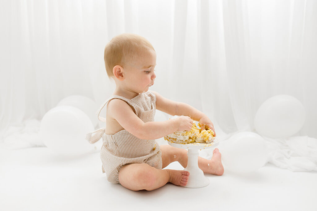 Baby sits for Birthday Cake Smash Photography in Charleston, SC Portrait Studio - Holy City Babies. 