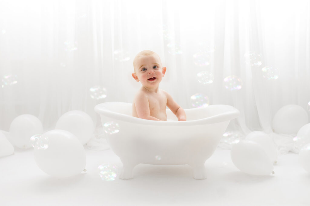 Baby sits for Birthday Cake Smash Photography in Charleston, SC Portrait Studio - Holy City Babies. 