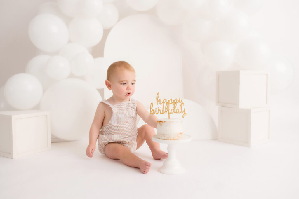 Baby sits for Birthday Cake Smash Photography in Charleston, SC Portrait Studio - Holy City Babies. 