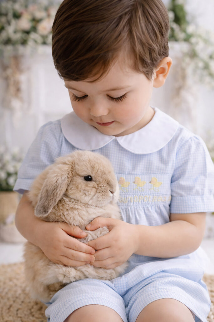 Little boy holds a bunny during Easter Mini Sessions in Charleston. 