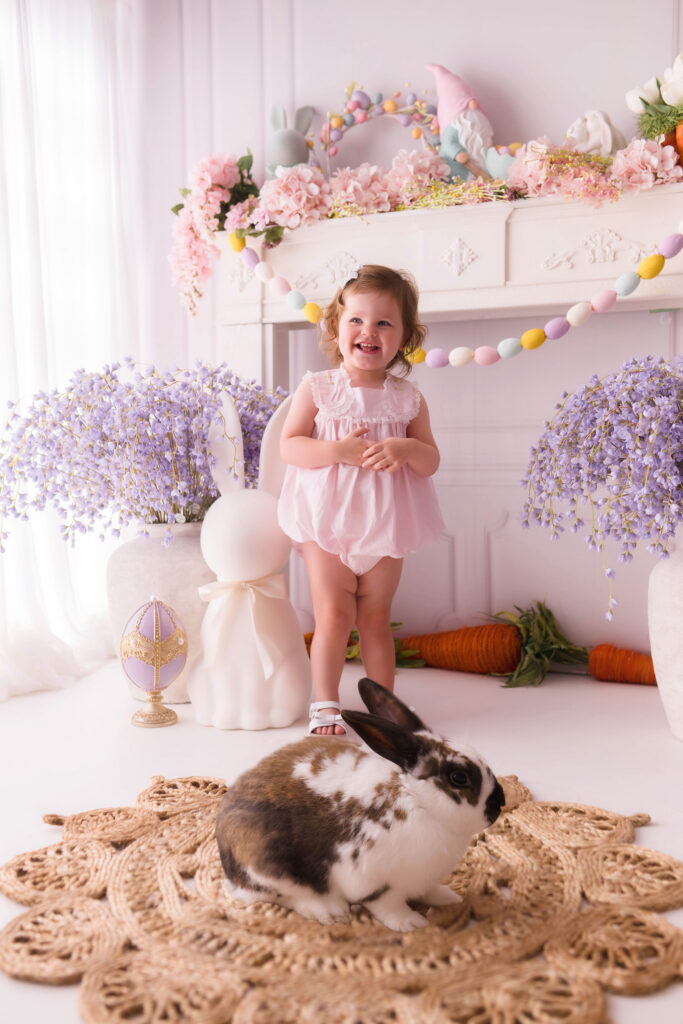Toddler interacts with a live bunny  during Easter Mini Session at Holy City Babies Portrait Studio in Charleston, SC. 