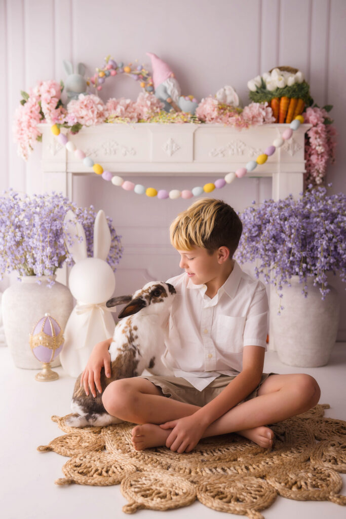 Little boy pets a live bunny  during Easter Mini Session at Holy City Babies Portrait Studio in Charleston, SC. 