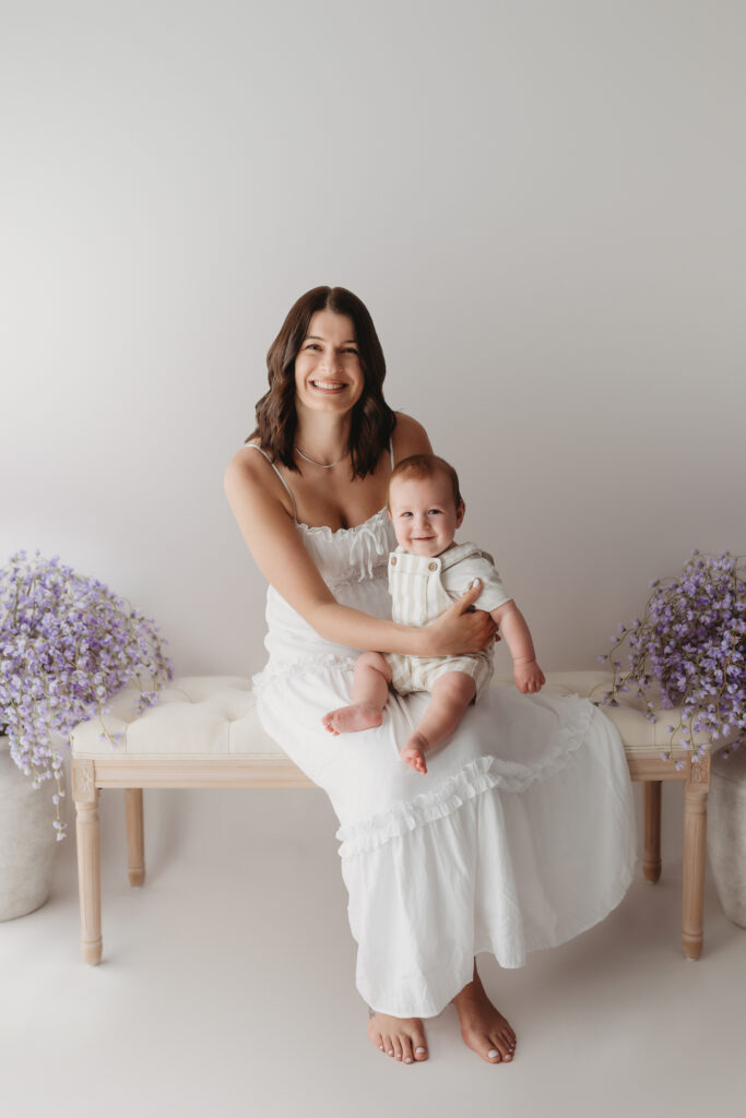 Charleston Mini Sessions - Mother embraces her baby during Mother's Day Mini Sessions at Holy City Babies Portrait Studio in Charleston, SC.