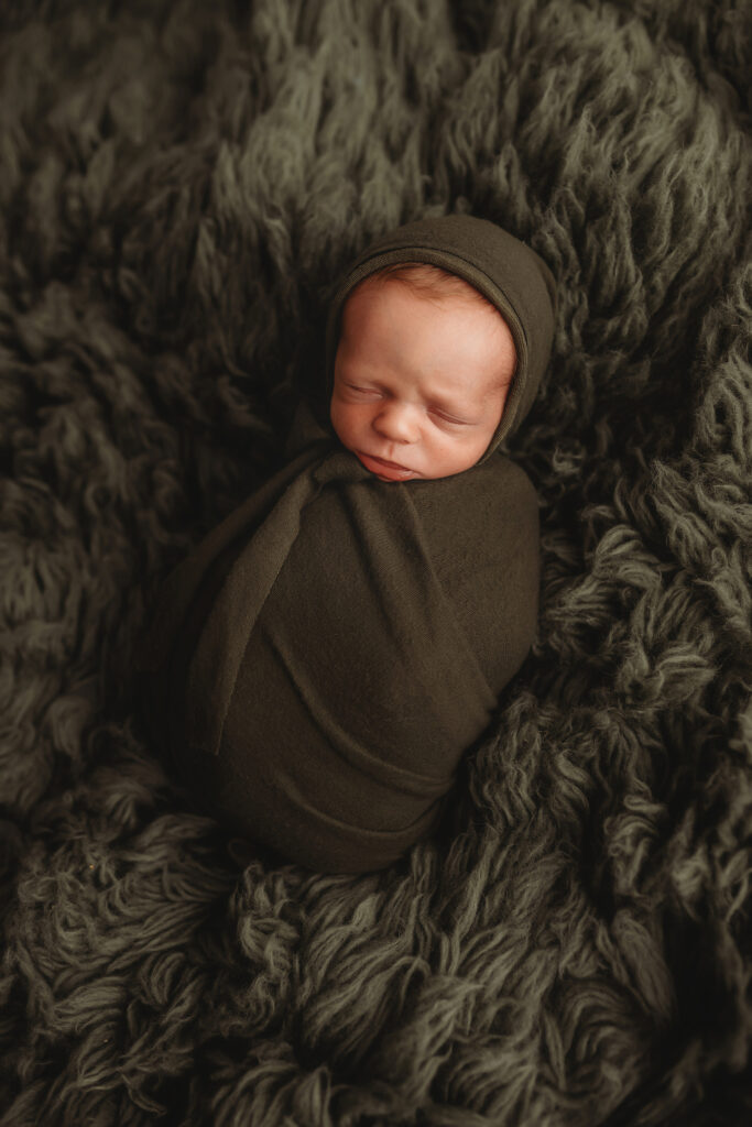 Newborn baby posed during Luxury Newborn Photography in Charleston SC