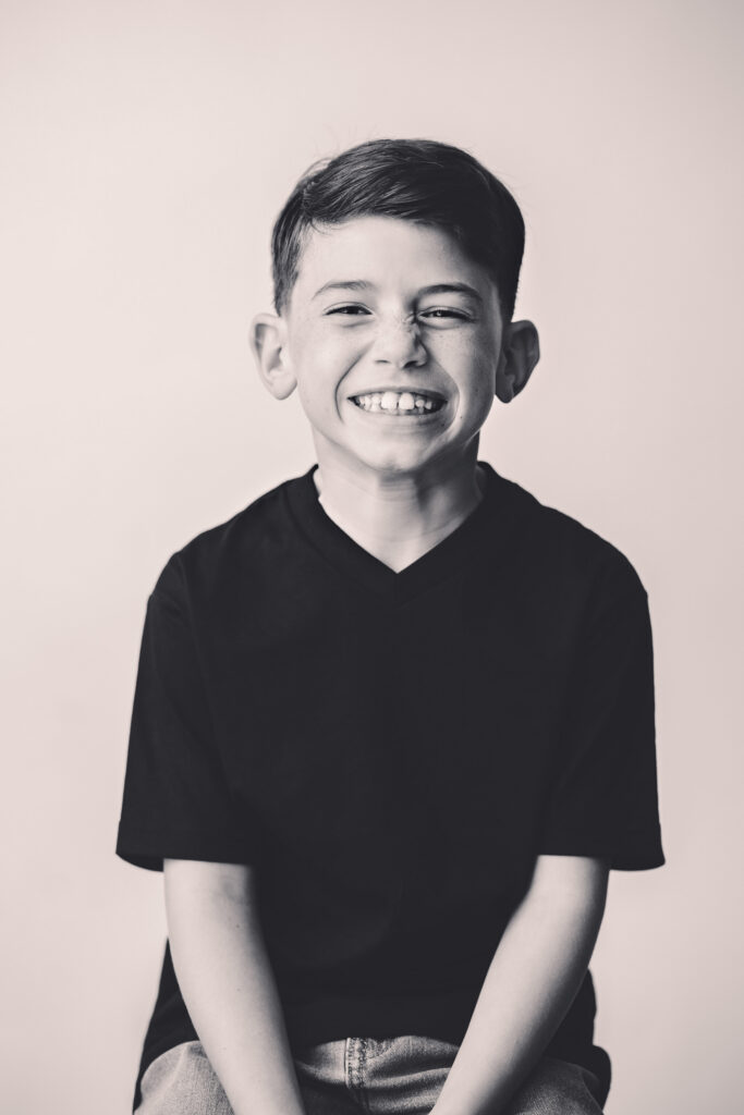 Young boy sits for Personality Portraits in Charleston at Holy City Babies Portrait Studio. 