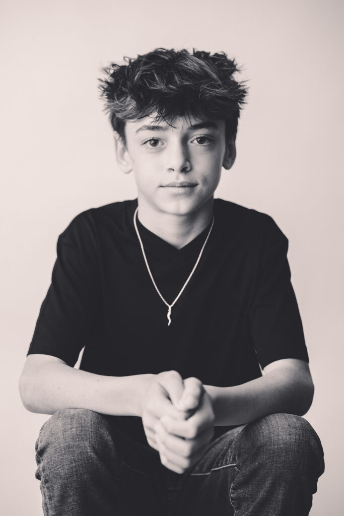 Young boy sits for Personality Portraits in Charleston at Holy City Babies Portrait Studio. 