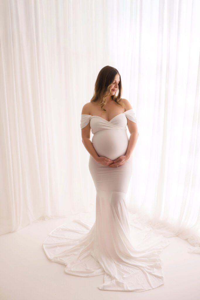 Pregnant woman poses for Studio Maternity Portraits at Holy City Babies Portrait Studio in Charleston, SC after learning about the Best Places to Host a Baby Shower in Charleston.