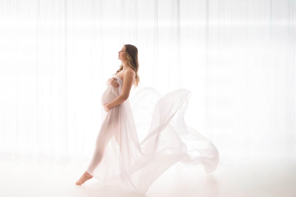 Pregnant woman poses for Studio Maternity Portraits at Holy City Babies Portrait Studio in Charleston, SC after learning about the Best Places to Host a Baby Shower in Charleston.