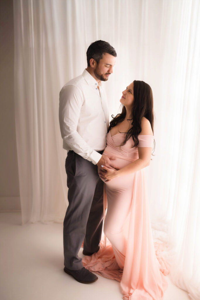 Expectant parents pose for Maternity Portraits at Holy City Babies Portrait Studio in Charleston, SC. 