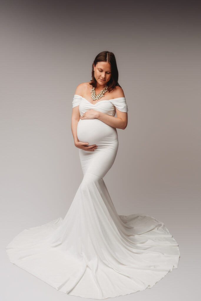 Pregnant woman poses for Maternity Portrait Session at Holy City Babies Maternity Portrait Studio in Charleston, SC after considering What to Wear for Maternity Photos in Charleston.