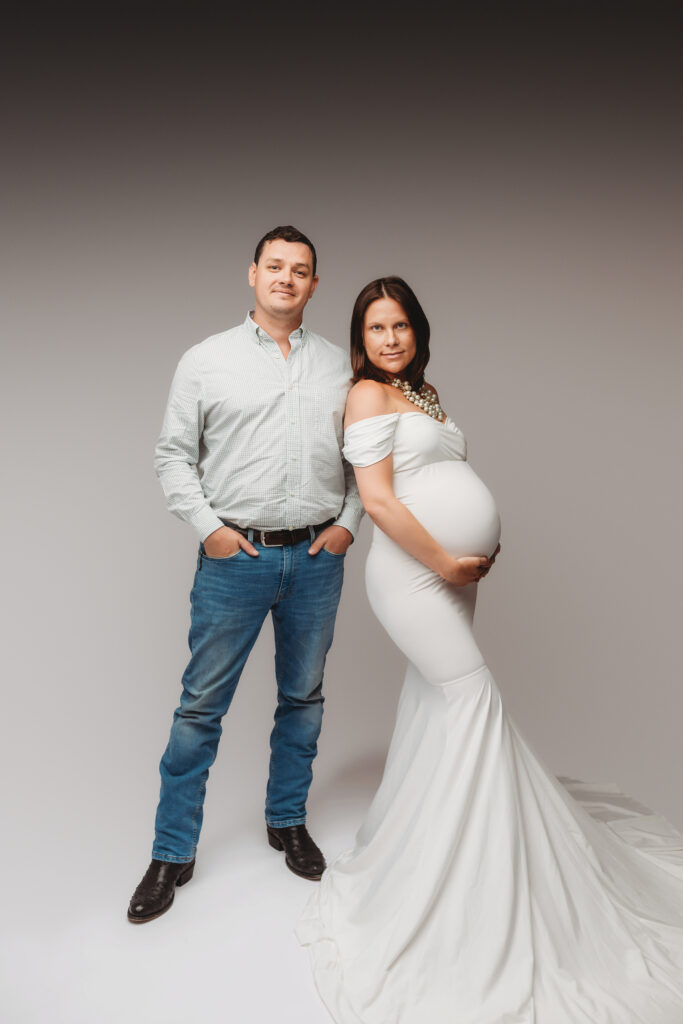 Expectant parents poses for Studio Maternity Portraits at Holy City Babies Portrait Studio in Charleston, SC after learning When to Schedule Maternity Photos in Charleston.