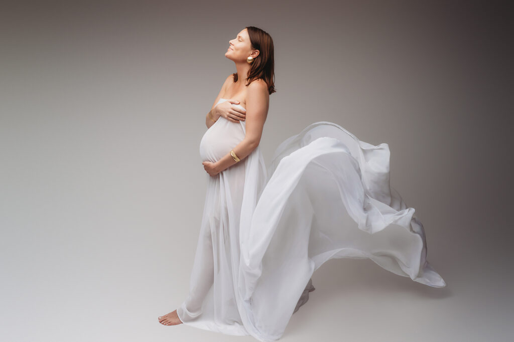 Expectant mother poses for Fine Art Studio Maternity Portraits at Holy City Babies Portrait Studio in Charleston, SC.