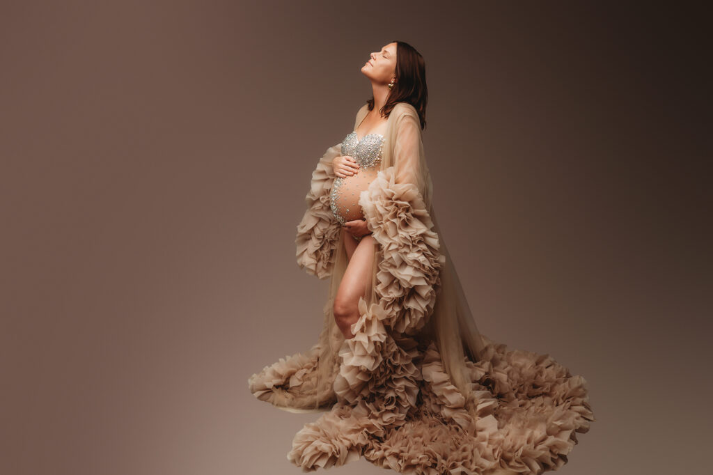 Expectant mother poses for Fine Art Studio Maternity Portraits at Holy City Babies Portrait Studio in Charleston, SC.