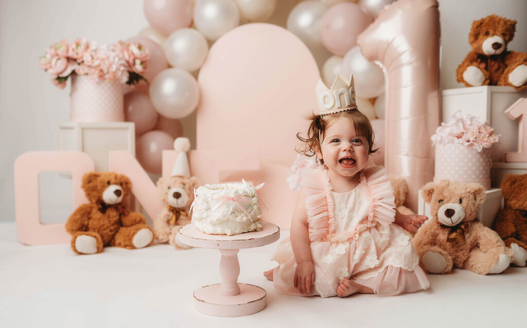 Charleston Cake Smash Photography - baby peers at the camera during a studio Milestone Portrait Session at Holy City Babies Portrait Studio in Charleston, SC. 