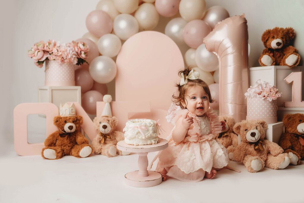 Charleston Milestone Photographer - baby peers at the camera during a studio Milestone Portrait Session at Holy City Babies Portrait Studio in Charleston, SC. 