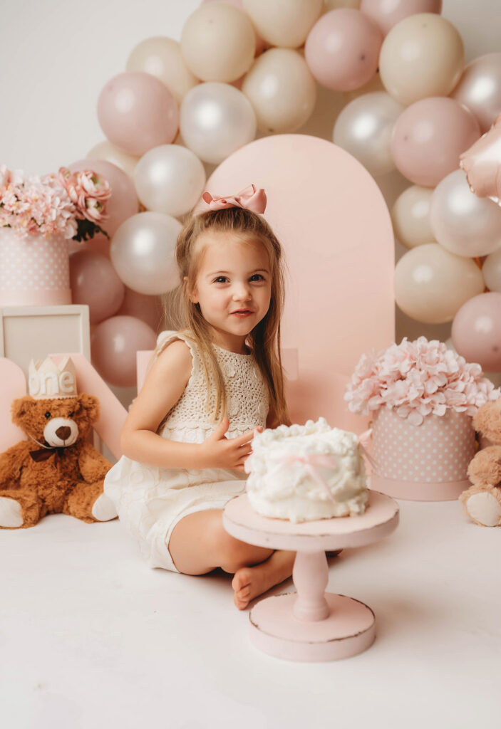 Charleston Milestone Photographer - baby peers at the camera during a studio Milestone Portrait Session at Holy City Babies Portrait Studio in Charleston, SC. 
