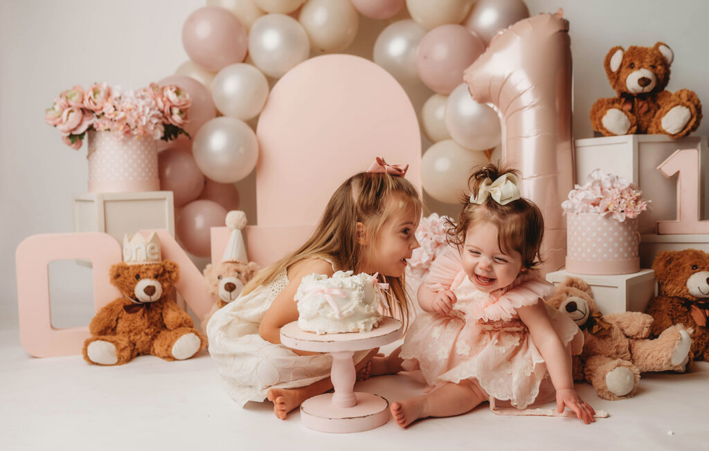 Charleston Milestone Photographer - baby peers at the camera during a studio Milestone Portrait Session at Holy City Babies Portrait Studio in Charleston, SC. 