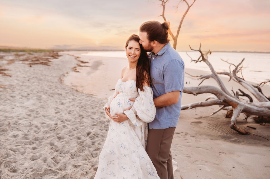 Expectant Parents pose for Maternity Portraits on Folly Beach in Charleston, SC after receiving Tips for Planning Beautiful Maternity Portraits on Folly Beach from Charleston's Leading Maternity Photographer, Brittany Sisk of Holy City Babies Portrait Studio.