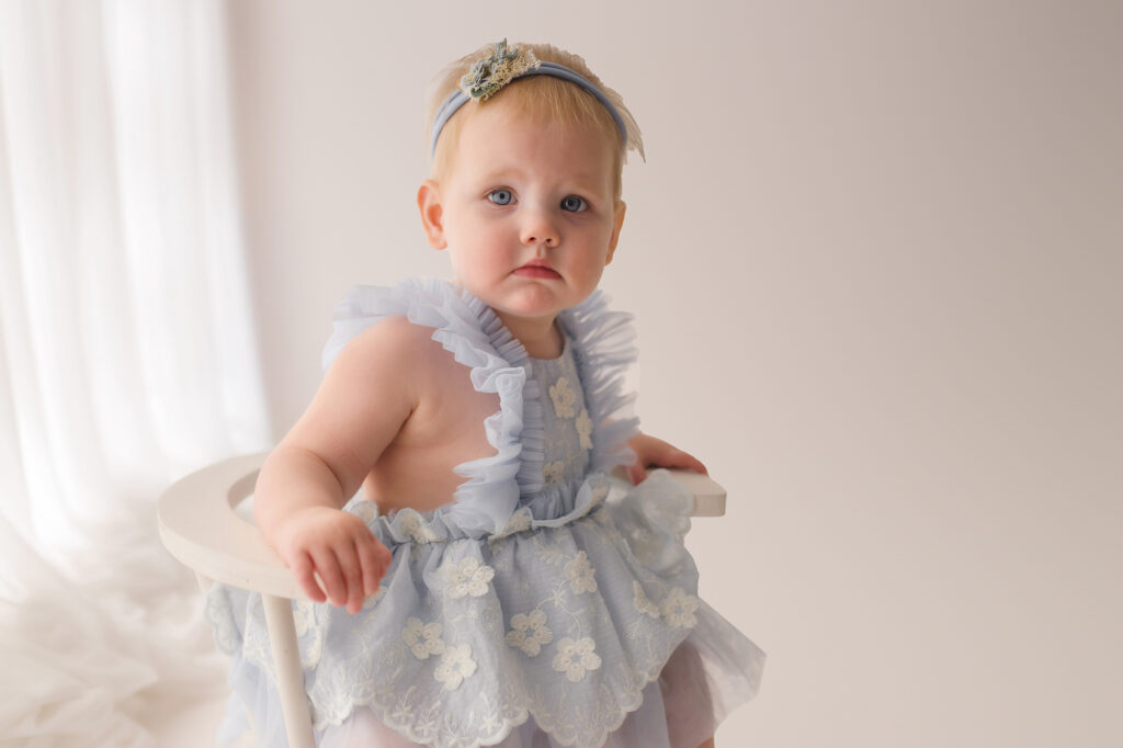 Baby celebrates first birthday with a Milestone, First Birthday Cake Smash Photoshoot at Holy City Babies Portrait Studio in Charleston, SC.