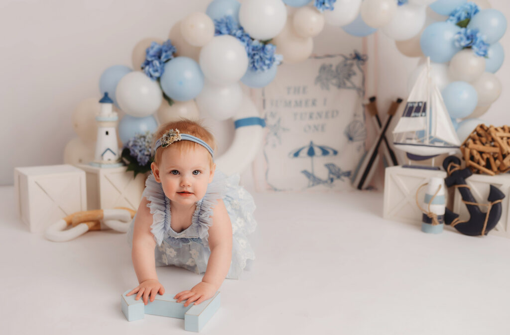 Baby celebrates first birthday with a Milestone, First Birthday Cake Smash Photoshoot at Holy City Babies Portrait Studio in Charleston, SC.