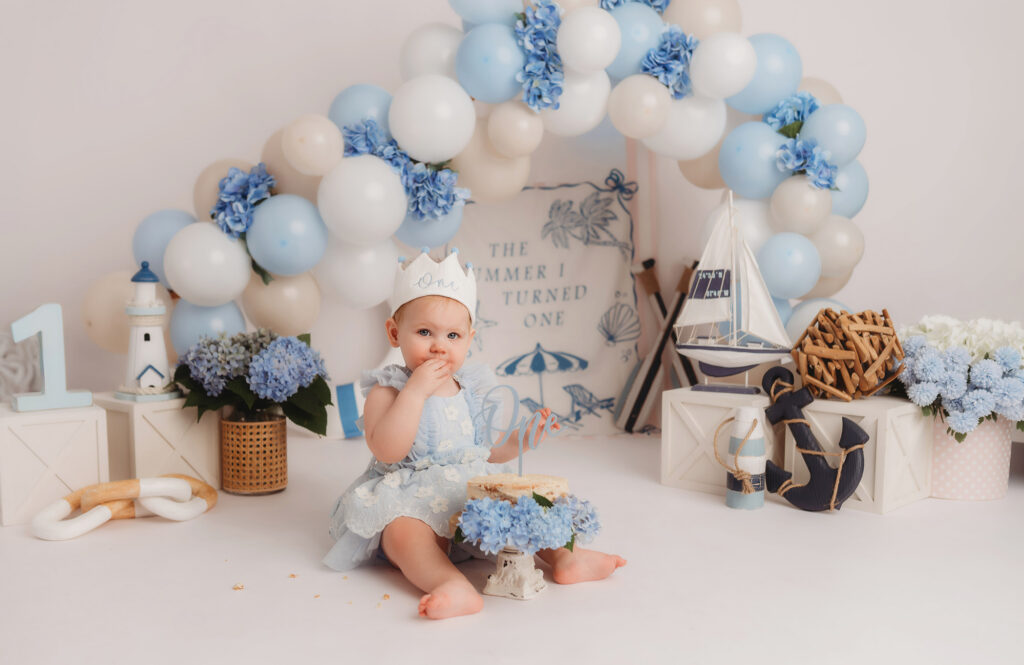 Baby celebrates first birthday with a Milestone, First Birthday Cake Smash Photoshoot at Holy City Babies Portrait Studio in Charleston, SC.