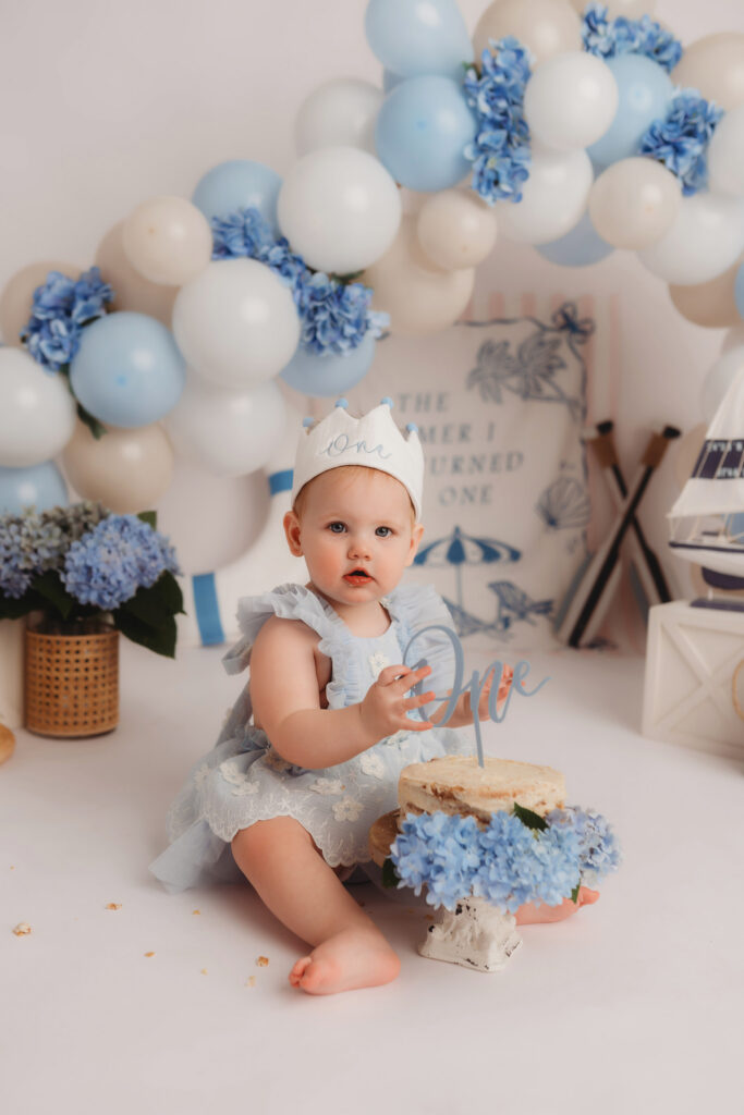 Baby celebrates first birthday with a Milestone, First Birthday Cake Smash Photoshoot at Holy City Babies Portrait Studio in Charleston, SC.