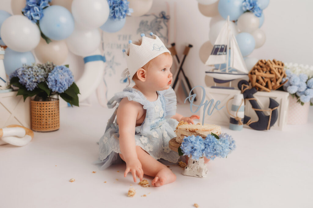 Baby celebrates first birthday with a Milestone, First Birthday Cake Smash Photoshoot at Holy City Babies Portrait Studio in Charleston, SC.
