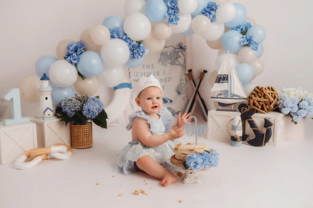 Baby celebrates first birthday with a Milestone, First Birthday Cake Smash Photoshoot at Holy City Babies Portrait Studio in Charleston, SC.