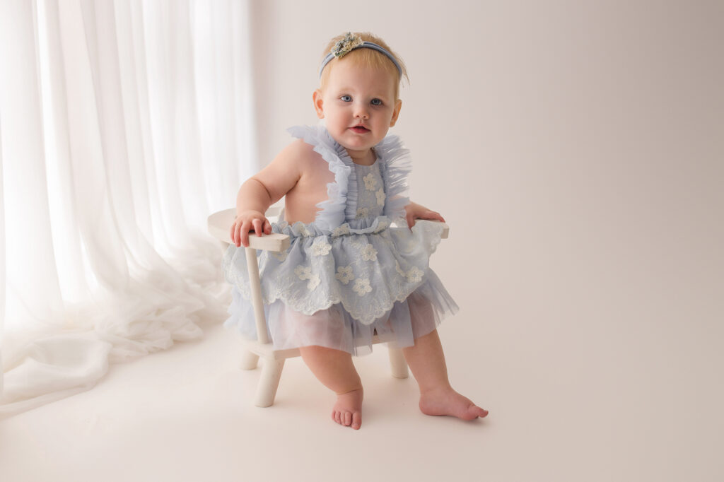 Baby celebrates first birthday with a Milestone, First Birthday Cake Smash Photoshoot at Holy City Babies Portrait Studio in Charleston, SC.