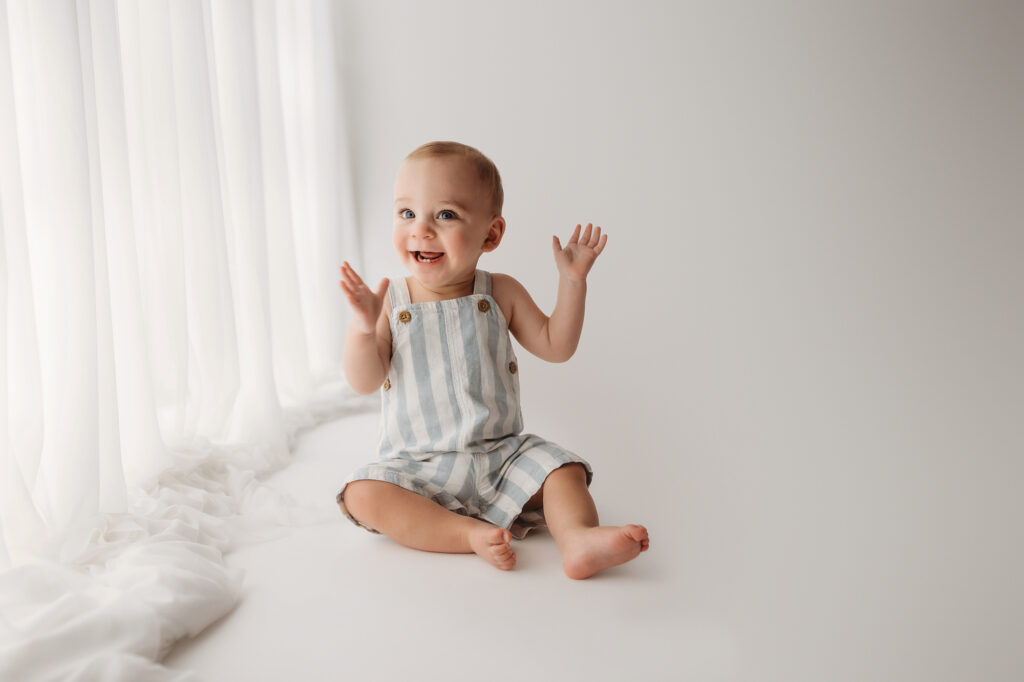 Baby celebrates first birthday with a Milestone, First Birthday Cake Smash Photoshoot at Holy City Babies Portrait Studio in Charleston, SC.