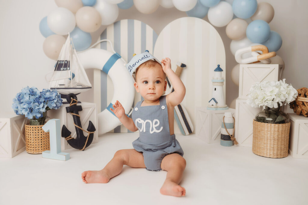 Baby celebrates first birthday with a Milestone, First Birthday Cake Smash Photoshoot at Holy City Babies Portrait Studio in Charleston, SC.