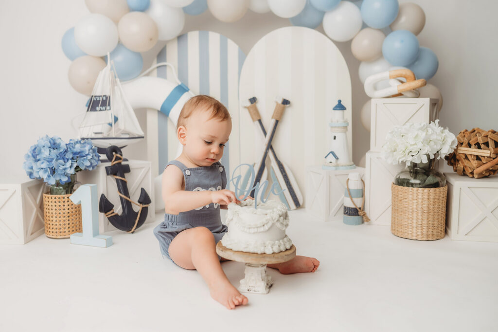 Baby celebrates first birthday with a Milestone, First Birthday Cake Smash Photoshoot at Holy City Babies Portrait Studio in Charleston, SC.