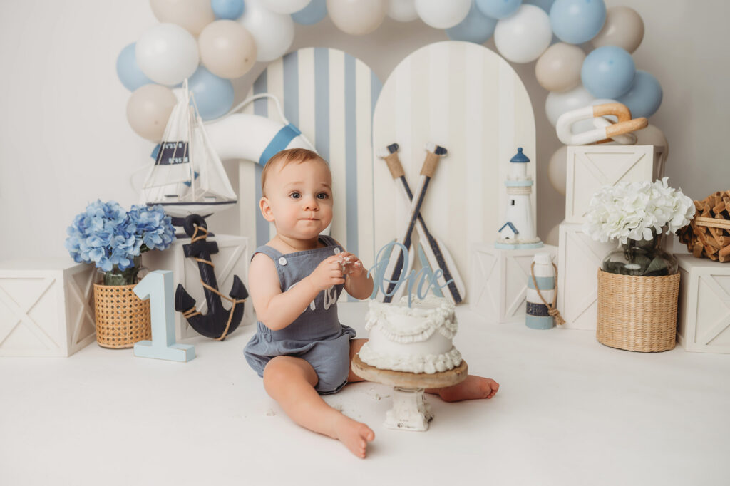 Baby celebrates first birthday with a Milestone, First Birthday Cake Smash Photoshoot at Holy City Babies Portrait Studio in Charleston, SC.