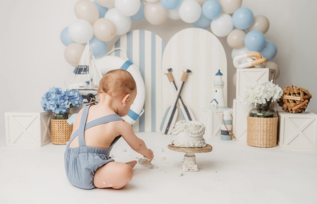 Baby celebrates first birthday with a Milestone, First Birthday Cake Smash Photoshoot at Holy City Babies Portrait Studio in Charleston, SC.