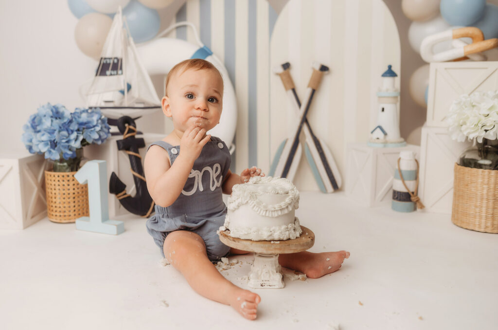 Baby celebrates first birthday with a Milestone, First Birthday Cake Smash Photoshoot at Holy City Babies Portrait Studio in Charleston, SC.