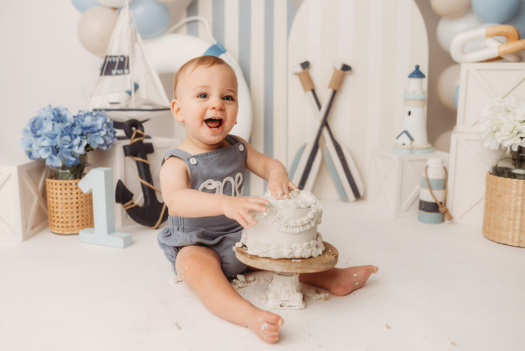 Baby celebrates first birthday with a Milestone, First Birthday Cake Smash Photoshoot at Holy City Babies Portrait Studio in Charleston, SC.