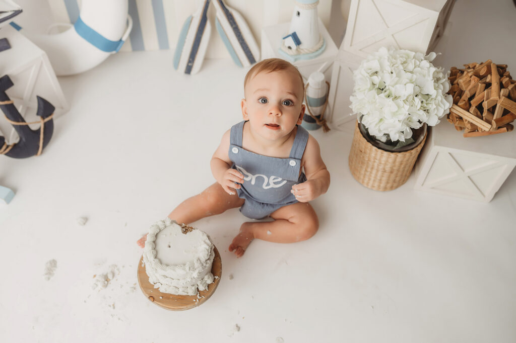 Baby celebrates first birthday with a Milestone, First Birthday Cake Smash Photoshoot at Holy City Babies Portrait Studio in Charleston, SC.