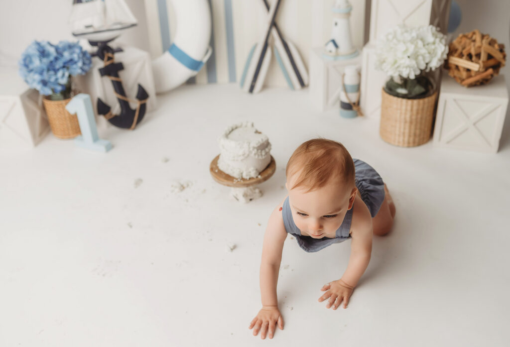 Baby celebrates first birthday with a Milestone, First Birthday Cake Smash Photoshoot at Holy City Babies Portrait Studio in Charleston, SC.