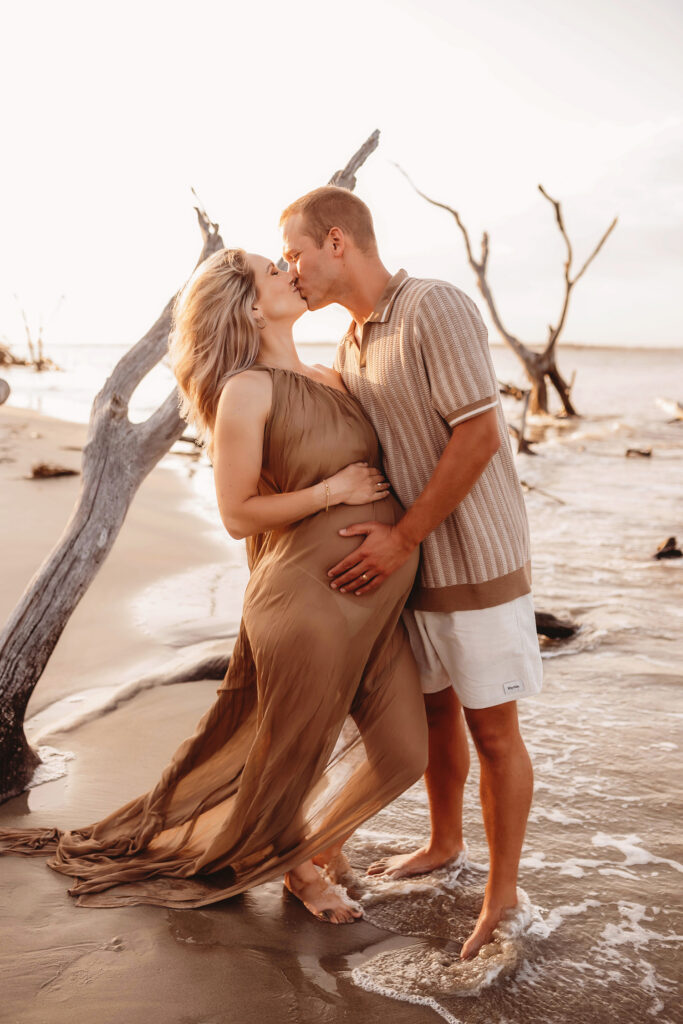 Expectant parents pose for Maternity Portraits at Folly Beach in Charleston, SC.