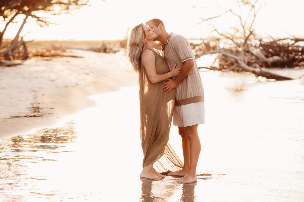 Expectant parents pose for Maternity Portraits at Folly Beach in Charleston, SC.