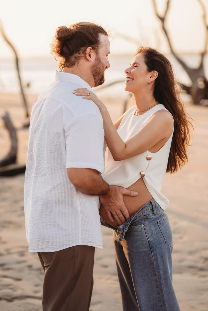 Expectant Parents pose for Maternity Photos on Folly beach in Charleston, SC.