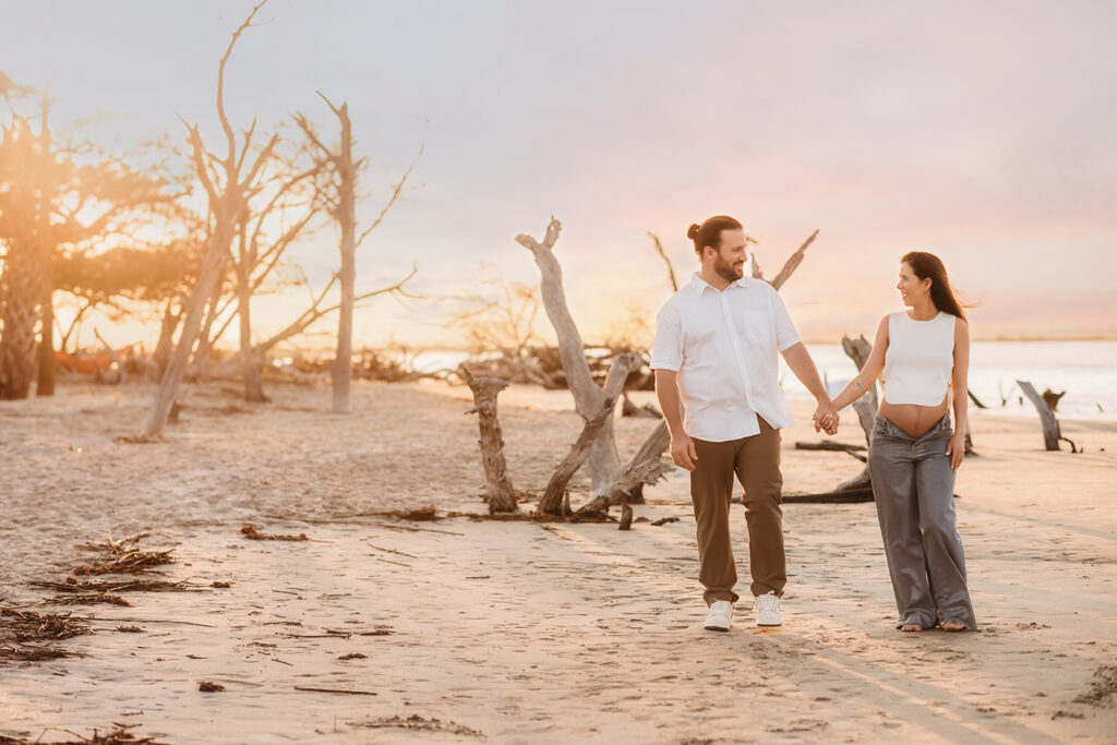 Expectant Parents pose for Maternity Photos on Folly beach in Charleston, SC.