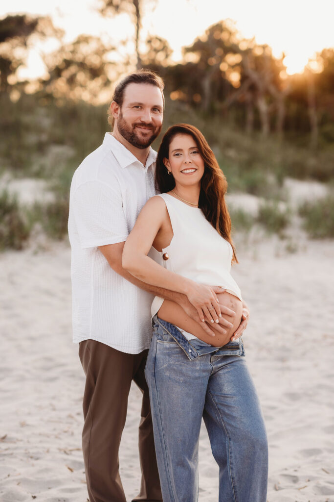 Expectant Parents pose for Maternity Photos on Folly beach in Charleston, SC.